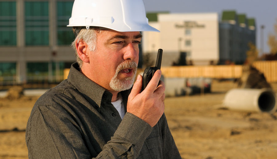 Construction foreman using a battery powered two-way radio 