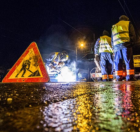 Workers filling in pot holes