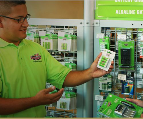 All Battery Center employee showcasing products