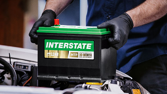 Tech installing an Interstate battery