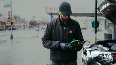 Technician holding battery tester